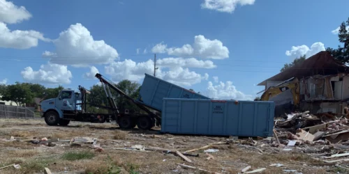dumptruck loading up debris filled dumpster wichita ks